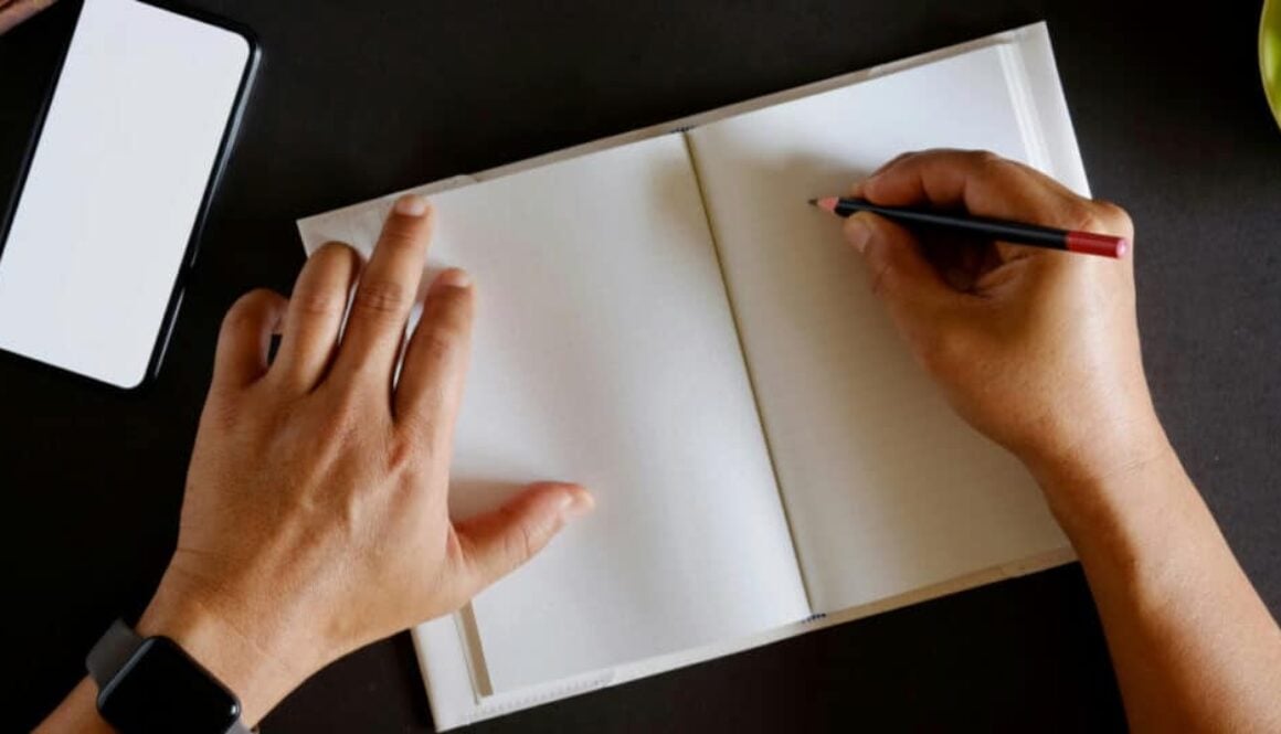A man begins to write his novel in a blank notebook.
