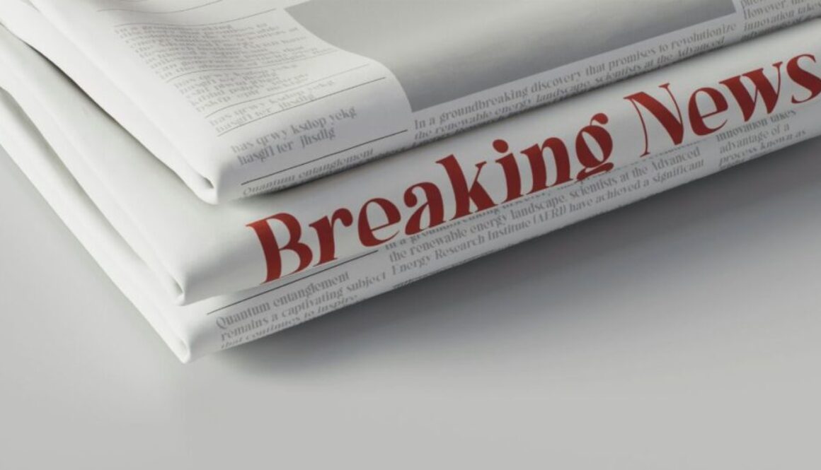 a stack of newspapers with red text