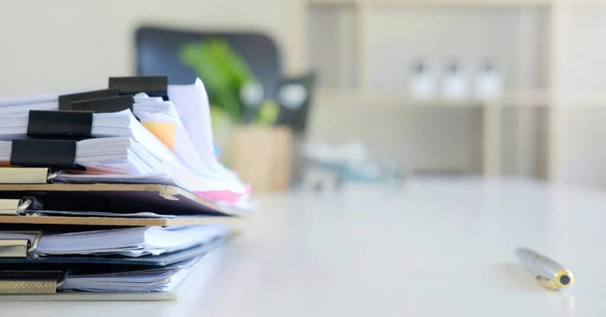 a stack of papers on clip boards and bound with binder clips on a desk