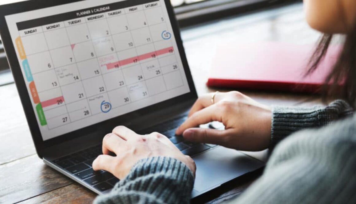 a person using a planner and calendar app on a laptop