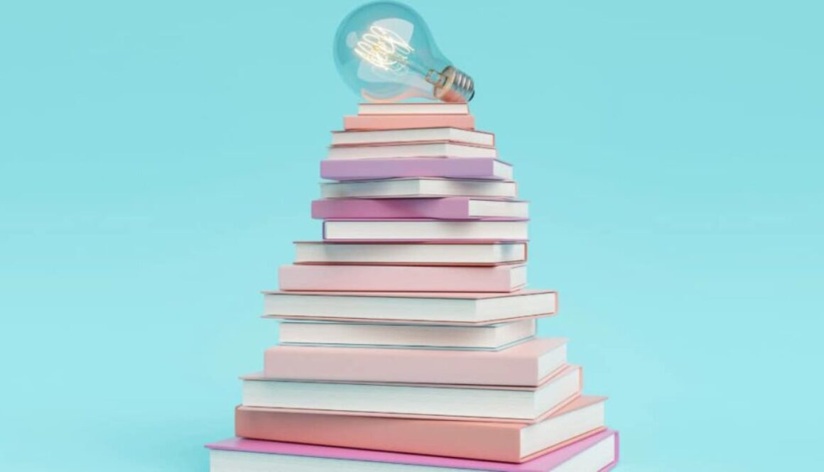 a lightbulb resting on a stack of books