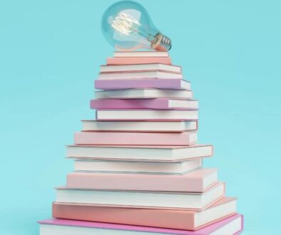 a lightbulb resting on a stack of books