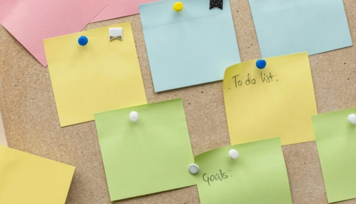 sticky notes thumbtacked to a bulletin board