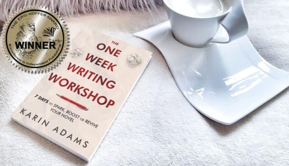 The One Week Writing Workshop book reset on a white blanket beside a coffee cup and a sticker declaring it a winner in The Eric Hoffer Book Award.